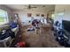 Large living room with a ceiling fan, sofas, open floor plan and a view of the dining room at 15920 Sw 49Th Court Rd, Ocala, FL 34473