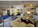 Open concept living and kitchen space with neutral-colored walls and ceiling fan at 15920 Sw 49Th Court Rd, Ocala, FL 34473