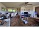 An expansive living room boasts a ceiling fan, sofas, and an open layout with dining area at 15920 Sw 49Th Court Rd, Ocala, FL 34473