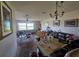 Spacious living room with overhead fan, sofa, and open layout to dining area with view of outside at 15920 Sw 49Th Court Rd, Ocala, FL 34473