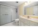 Bathroom featuring a glass door shower, vanity, mirror, and toilet in a well-lit space at 1640 Ne 40Th Ave # 107, Ocala, FL 34470