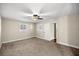 Cozy bedroom featuring neutral carpet, ceiling fan, and bright windows at 1640 Ne 40Th Ave # 107, Ocala, FL 34470