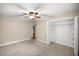 Cozy bedroom featuring neutral walls, carpeted floors, a ceiling fan, and a closet with ample storage space at 1640 Ne 40Th Ave # 107, Ocala, FL 34470
