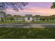 Exterior view of the charming condo building with well-maintained landscaping and ample parking space at 1640 Ne 40Th Ave # 107, Ocala, FL 34470