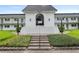 Exterior of the entrance to Silver Pines showing the stairs leading up to an arched entrance and American flag at 1640 Ne 40Th Ave # 107, Ocala, FL 34470