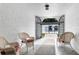 Welcoming entryway adorned with wicker chairs, leading to a serene pool area at 1640 Ne 40Th Ave # 107, Ocala, FL 34470