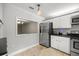 Bright kitchen with stainless steel appliances, ample cabinet space, and a pass-through window to an adjoining room at 1640 Ne 40Th Ave # 107, Ocala, FL 34470