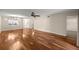 Expansive living room with gleaming hardwood floors, ceiling fan, and neutral wall color at 1640 Ne 40Th Ave # 107, Ocala, FL 34470