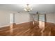 Large living room featuring hardwood floors, ceiling fan, decorative chandelier, and sliding glass door at 1640 Ne 40Th Ave # 107, Ocala, FL 34470
