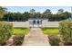 Inviting community pool area enclosed by a white fence and lush landscaping at 1640 Ne 40Th Ave # 107, Ocala, FL 34470