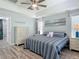 Charming bedroom with coastal decor, ceiling fan, and en-suite bath at 16954 Se 93Rd Cuthbert Cir, The Villages, FL 32162