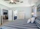 Open bedroom showing a comfy bed and an ensuite bathroom and living room at 16954 Se 93Rd Cuthbert Cir, The Villages, FL 32162