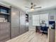 Stylish bedroom with a murphy bed, built in shelves, desk and laminate flooring at 16954 Se 93Rd Cuthbert Cir, The Villages, FL 32162