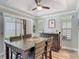 Bright dining room with a rustic wood table, bar and views to outdoor patio at 16954 Se 93Rd Cuthbert Cir, The Villages, FL 32162