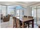 Open concept view of dining room with wood table, and sitting and bedrooms beyond at 16954 Se 93Rd Cuthbert Cir, The Villages, FL 32162