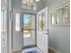 Bright entryway featuring a glass storm door with natural light and a view of the front yard at 16954 Se 93Rd Cuthbert Cir, The Villages, FL 32162