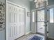 Bright entryway with a closet and clear view of the front yard through the storm door at 16954 Se 93Rd Cuthbert Cir, The Villages, FL 32162