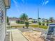 View from the front porch featuring a view of the manicured lawn and palm trees at 16954 Se 93Rd Cuthbert Cir, The Villages, FL 32162