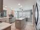 Bright kitchen with an island, stainless appliances, and adjacent breakfast nook at 16954 Se 93Rd Cuthbert Cir, The Villages, FL 32162