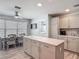 Kitchen with island, dining area, and neutral-toned cabinets and countertops at 16954 Se 93Rd Cuthbert Cir, The Villages, FL 32162