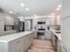 Open-concept kitchen with a central island, stainless steel appliances, and sleek cabinetry at 16954 Se 93Rd Cuthbert Cir, The Villages, FL 32162