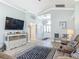 Bright living room with hardwood floors, white trim, and console with baskets and storage at 16954 Se 93Rd Cuthbert Cir, The Villages, FL 32162