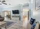 Living room showcasing a large TV and open floor plan to kitchen and dining at 16954 Se 93Rd Cuthbert Cir, The Villages, FL 32162