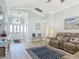 Welcoming living room features hardwood floors, white trim, and modern furniture at 16954 Se 93Rd Cuthbert Cir, The Villages, FL 32162