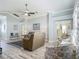 Spacious living room features hardwood floors, white trim, and stylish, neutral furniture at 16954 Se 93Rd Cuthbert Cir, The Villages, FL 32162