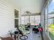 Enclosed lanai with casual seating, ceiling fans and peaceful view at 16954 Se 93Rd Cuthbert Cir, The Villages, FL 32162