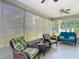 Enclosed patio with comfortable seating, ceiling fans and screens at 16954 Se 93Rd Cuthbert Cir, The Villages, FL 32162