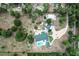 Aerial view of the home and grounds, including a circular drive, pool, outbuildings and lush landscaping at 170 Sw 80Th St, Ocala, FL 34476