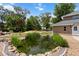 View of pond in the backyard surrounded by rock and lush vegetation on a sunny day at 170 Sw 80Th St, Ocala, FL 34476