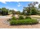 View of backyard waterfall flowing into the pond that is surrounded by rocks and lush vegetation at 170 Sw 80Th St, Ocala, FL 34476