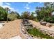 View of backyard waterfall surrounded by rock and vegetation in a park-like setting at 170 Sw 80Th St, Ocala, FL 34476