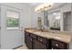 Bathroom with granite countertop, decorative vanity, and access door to the outside at 170 Sw 80Th St, Ocala, FL 34476