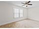 A well lit bedroom with tiled floor, ceiling fan and window with blinds creating a peaceful environment at 170 Sw 80Th St, Ocala, FL 34476