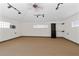 The bonus room has neutral carpeting, storage shelves, and track lighting at 170 Sw 80Th St, Ocala, FL 34476