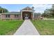 Charming single-story home featuring a stone facade, gabled entryway, and well-manicured front lawn at 170 Sw 80Th St, Ocala, FL 34476