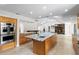 Open-concept kitchen with stainless steel appliances, large island, and marble countertops at 170 Sw 80Th St, Ocala, FL 34476