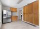 Spacious kitchen with stainless steel refrigerator, natural cabinets and granite countertops at 170 Sw 80Th St, Ocala, FL 34476
