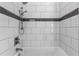 Modern shower showcasing a handheld shower head and sleek subway tile design at 170 Sw 80Th St, Ocala, FL 34476