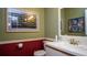 Bathroom with a decorative wainscoting, framed art and a vanity with a sink and mirror at 20820 River Dr # B32, Dunnellon, FL 34431