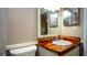 Bathroom showcasing unique wood countertop with vessel sink and white fixtures at 20820 River Dr # B32, Dunnellon, FL 34431