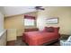 Bedroom with closet space, decor and a red comforter at 20820 River Dr # B32, Dunnellon, FL 34431