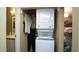 Convenient laundry closet with stacked washer and dryer unit, and shelving on the side at 20820 River Dr # B32, Dunnellon, FL 34431