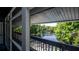 Balcony view overlooking a serene waterway surrounded by lush greenery and landscaping at 20820 River Dr # B32, Dunnellon, FL 34431