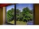 Bright window view of lush trees and an expansive green lawn at 20820 River Dr # B32, Dunnellon, FL 34431