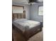 Cozy bedroom showcasing a wooden bed frame, carpet flooring and two windows with coverings at 2151 Se 177Th Ave, Silver Springs, FL 34488