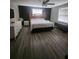 Spacious bedroom featuring wood-look flooring and a modern ceiling fan at 2151 Se 177Th Ave, Silver Springs, FL 34488